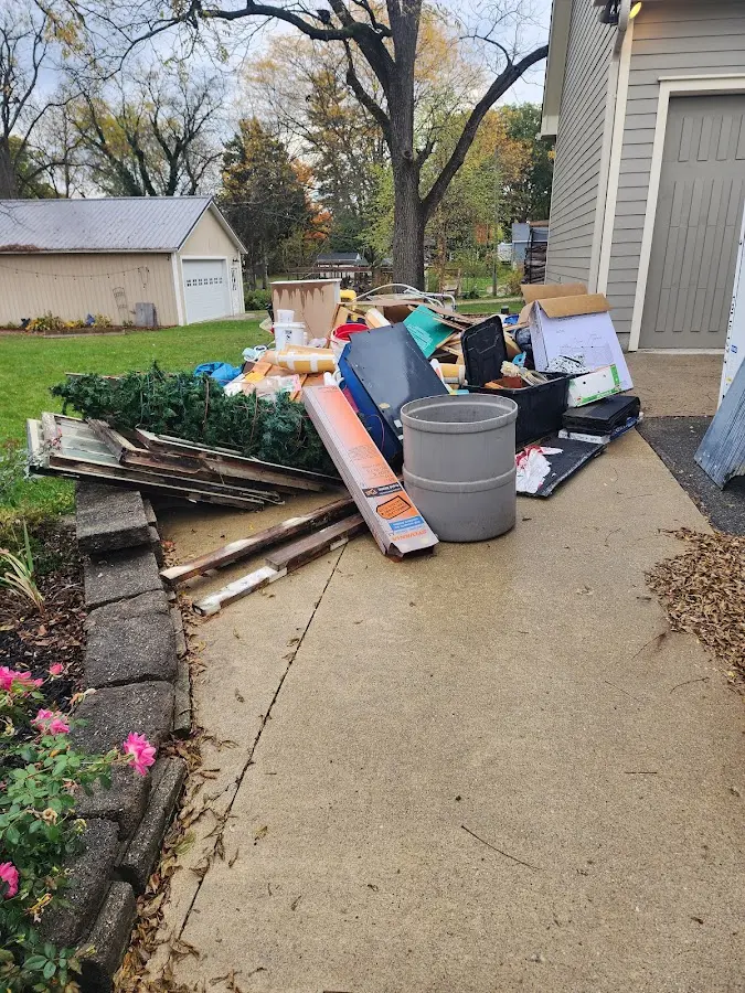 Dumpster being loaded with debris for 12 Yard Dumpster Rental in Wakefield